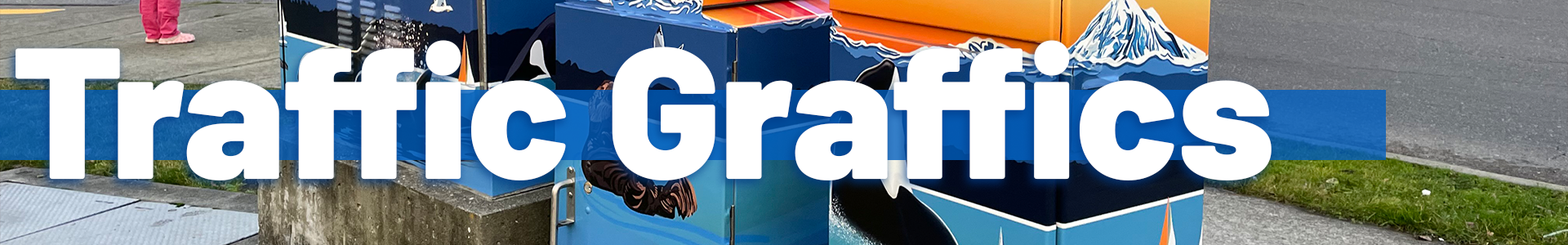 A painted utility box featuring colorful mountain, ocean, and wildlife artwork sits on a sidewalk, with large white text reading ‘Traffic Graffics’ across the center over a blue bar.